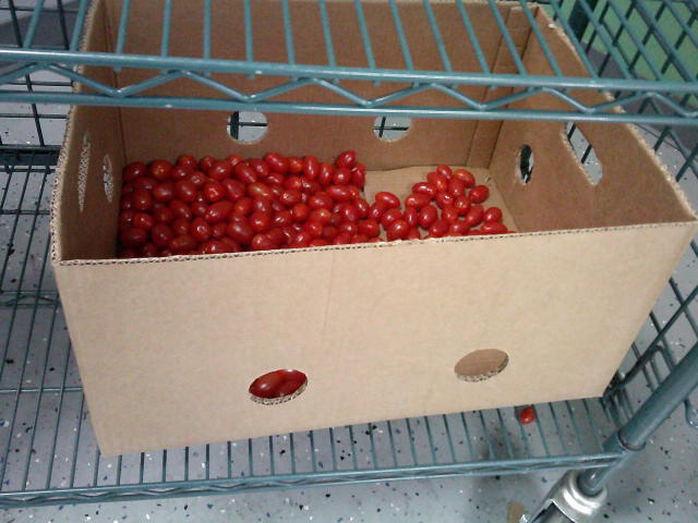 Banana box bottom filled with grape tomatoes.